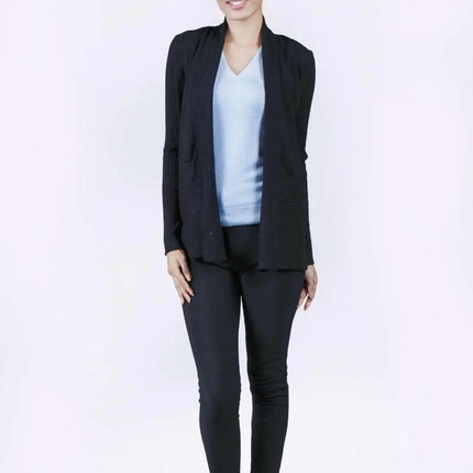 Elegant woman in black suit and blue top wearing luxurious Italian Cashmere Cardigan