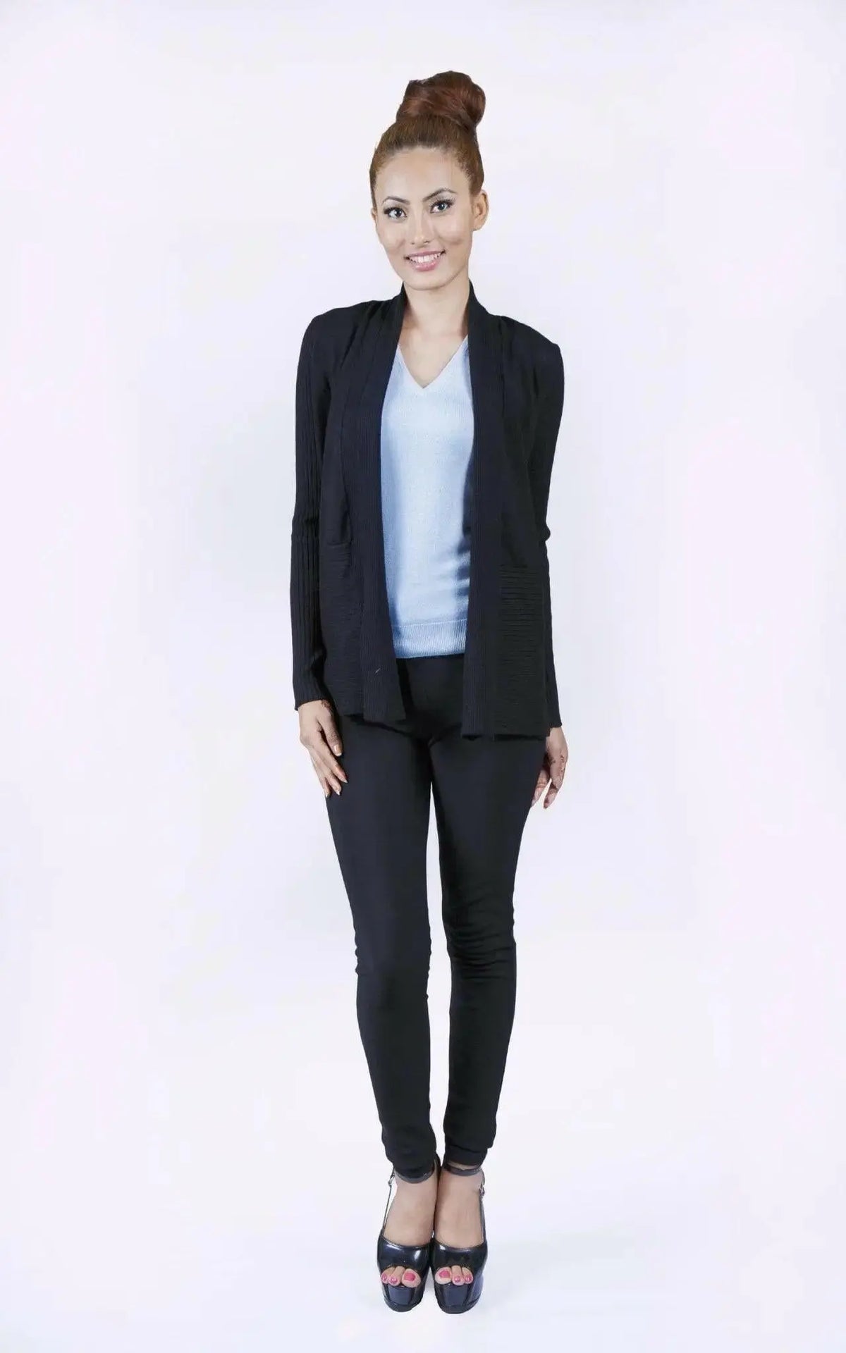 Elegant woman in black suit and blue top wearing luxurious Italian Cashmere Cardigan
