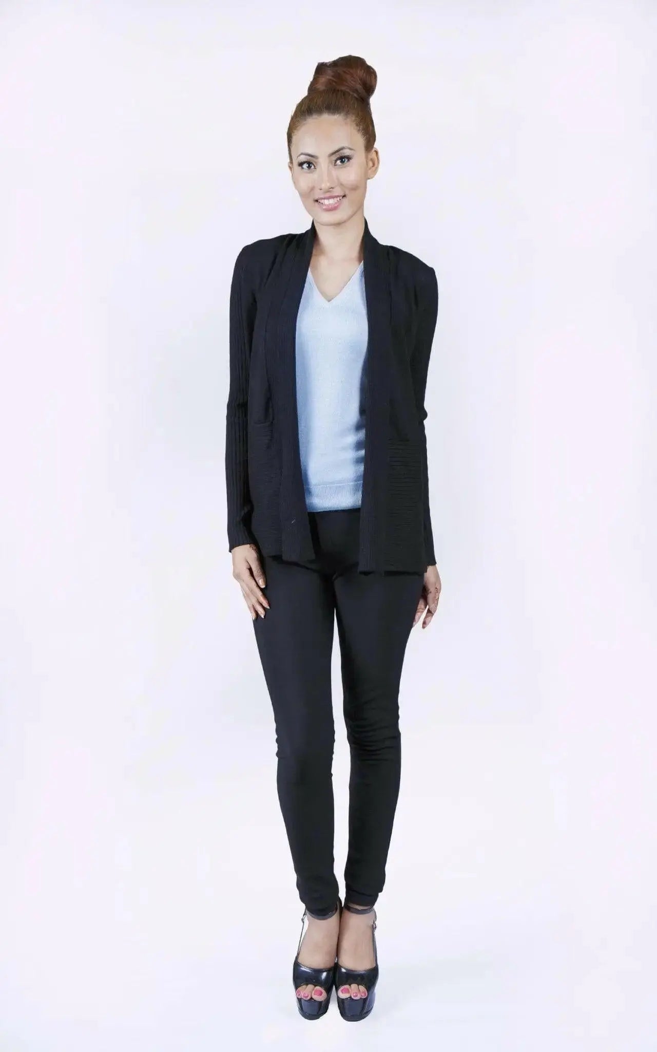 Elegant woman in black suit and blue top wearing luxurious Italian Cashmere Cardigan