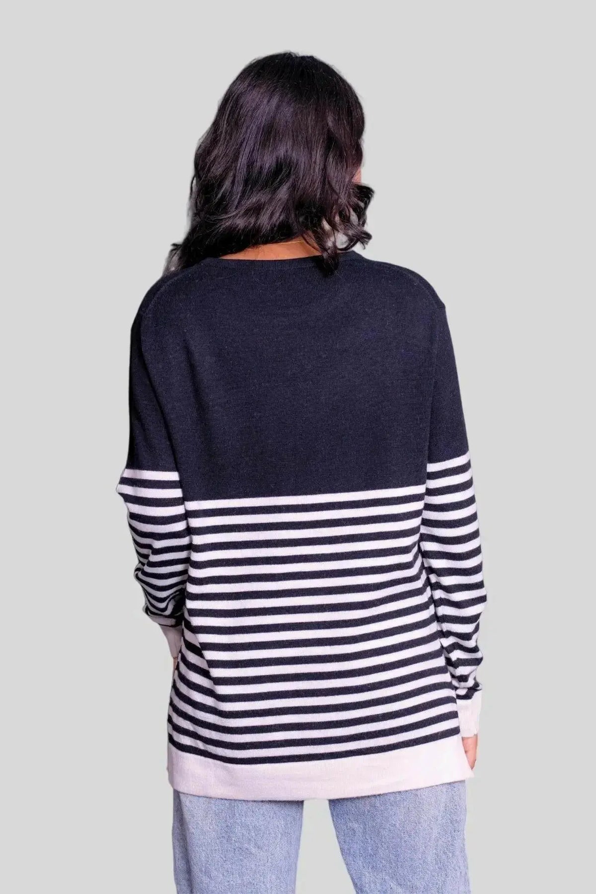 Luxurious Italian multi color pullover showcasing a woman in black and white striped sweater