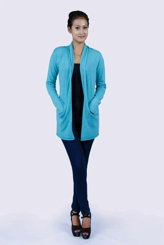 Luxurious Italian Cashmere Open Pocket Garment featuring a woman in a blue cardigan sweater and black top