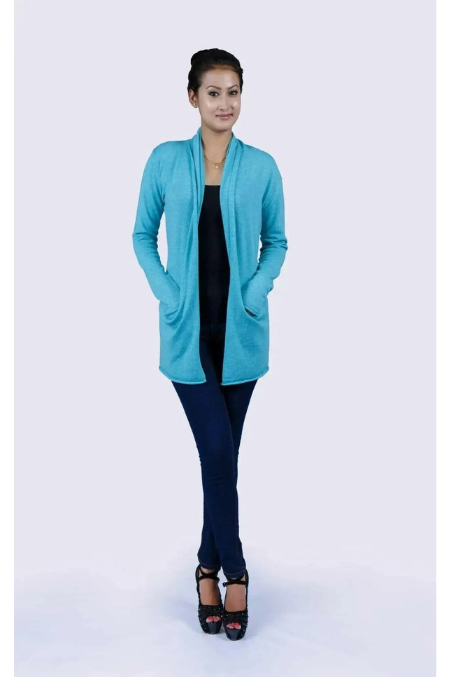 Luxurious Italian Cashmere Open Pocket Garment featuring a woman in a blue cardigan sweater and black top