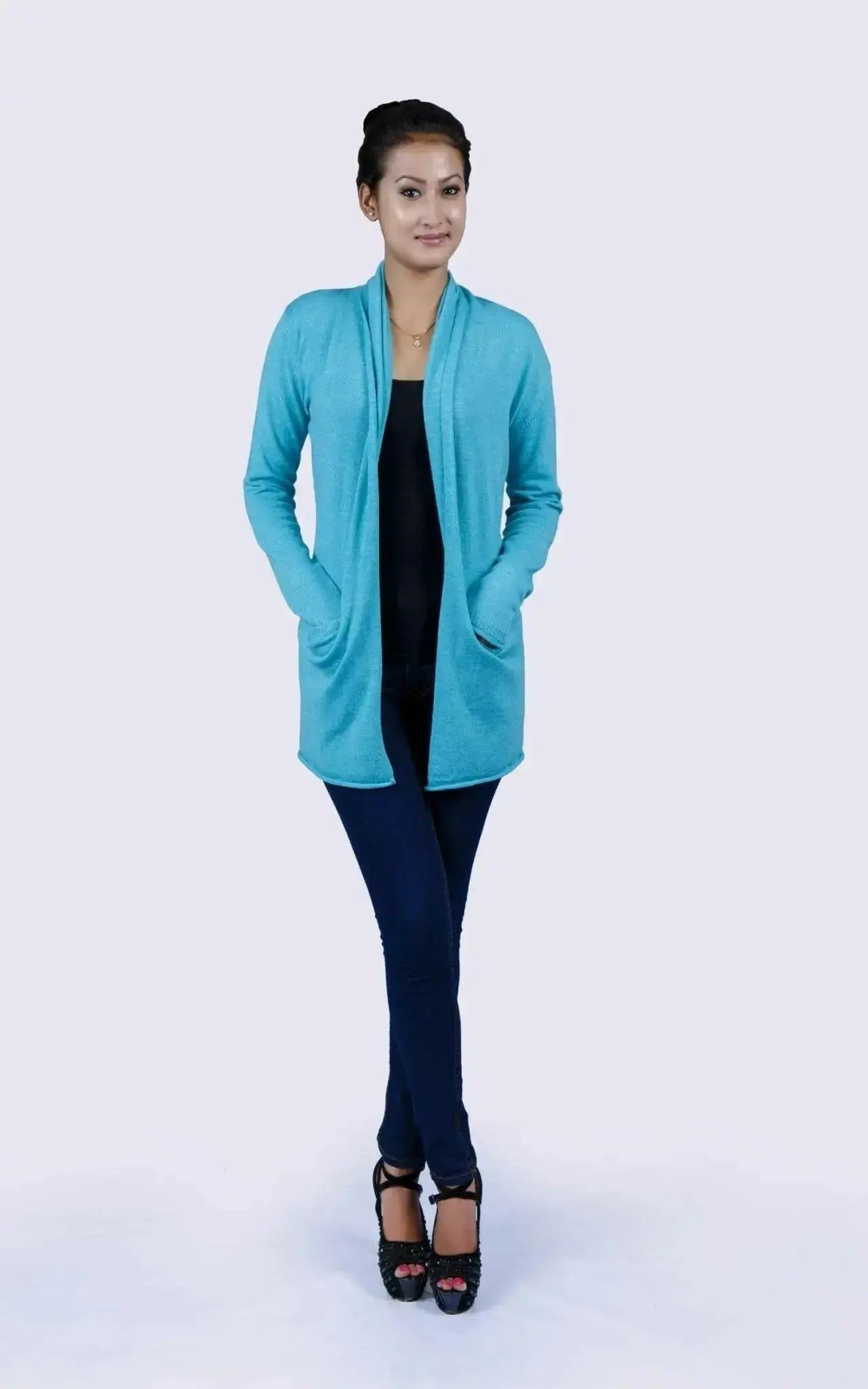Luxurious Italian Cashmere Open Pocket Garment featuring a woman in a blue cardigan sweater and black top