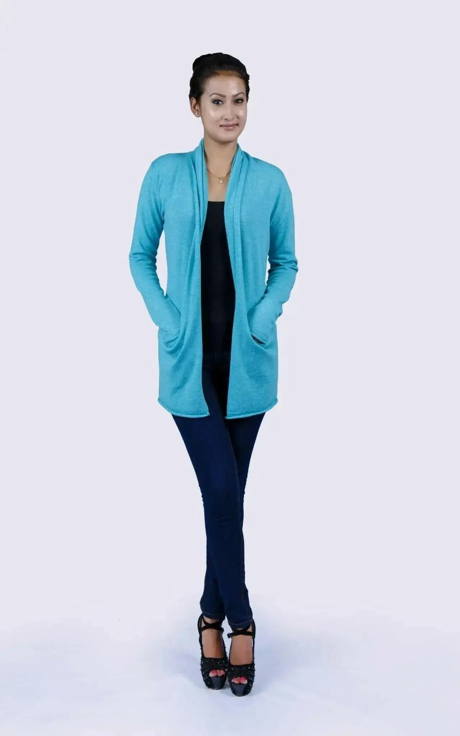 Luxurious Italian Cashmere Open Pocket Garment featuring a woman in a blue cardigan sweater and black top
