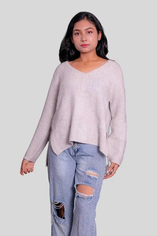 Woman in luxurious Italian cashmere pullover with ripped jeans
