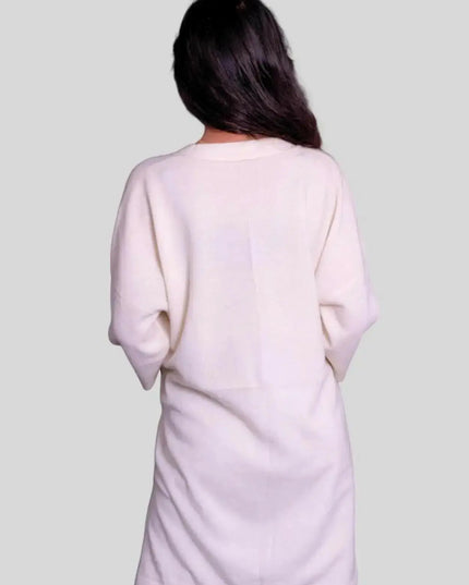 Woman wearing white cashmere pullover and black hat by Luxurious Italian Cashmere