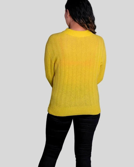 Woman wearing luxurious Italian cashmere pullover and black jeans