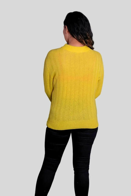 Woman wearing luxurious Italian cashmere pullover and black jeans