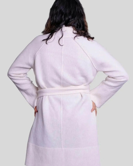 Woman wearing luxurious Italian cashmere robe in pink coat with white sweater