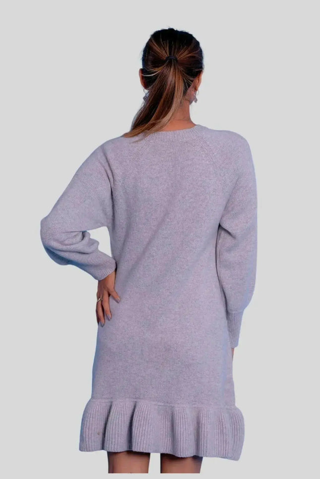 Woman wearing a grey cashmere ruffle dress