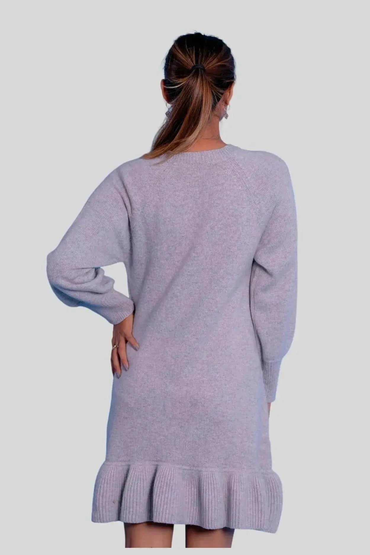 Woman wearing a grey cashmere ruffle dress