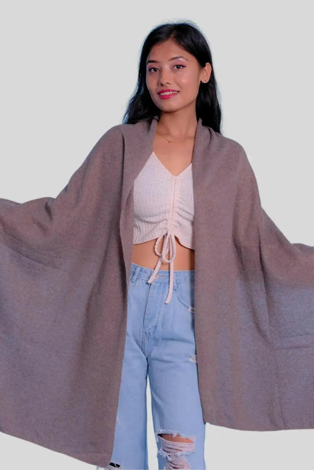 Woman in grey cape, white top, and blue jeans wearing Luxurious Italian Cashmere Scarf for winter wardrobe