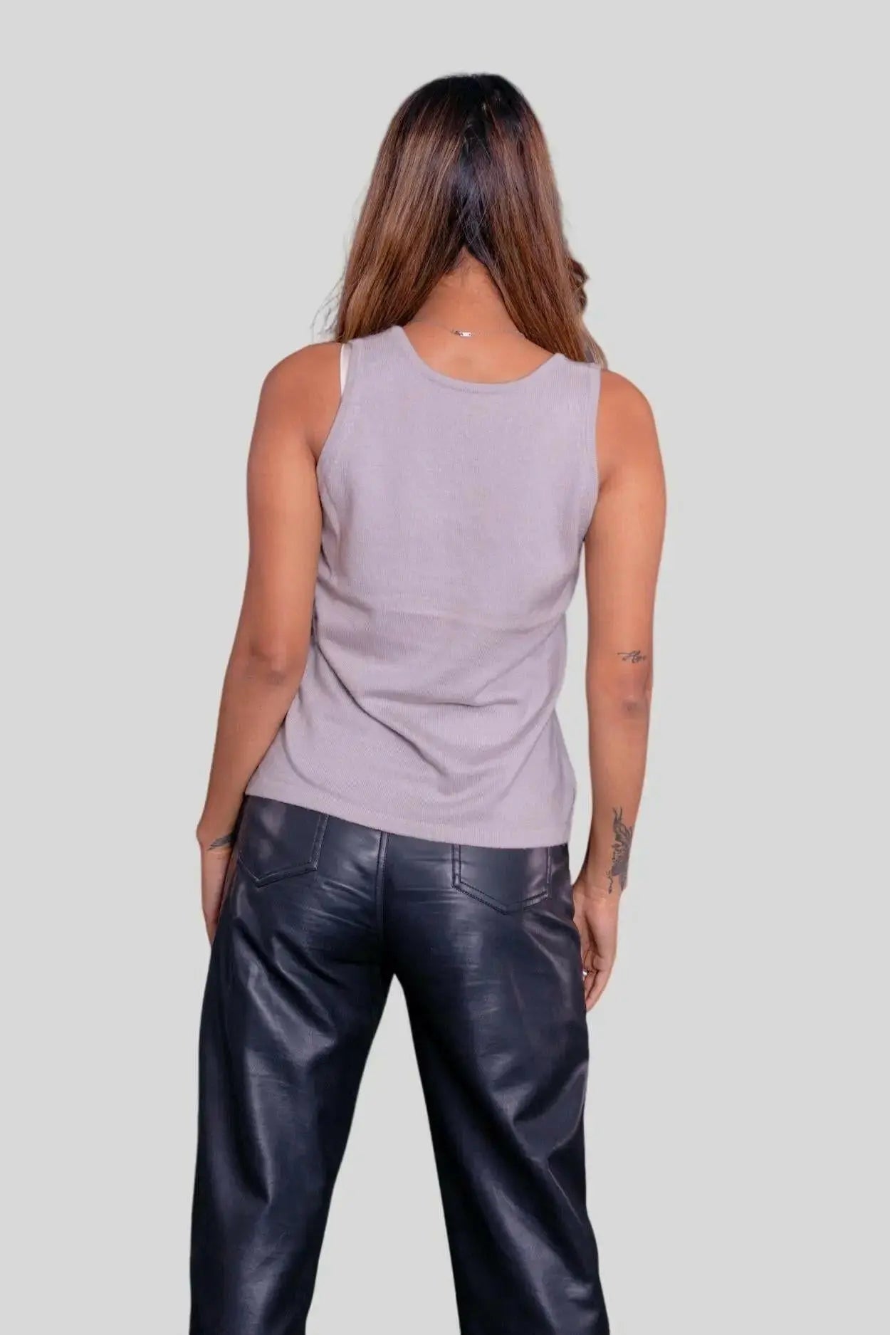 Woman in luxurious Italian cashmere top with flattering fit and black leather pants