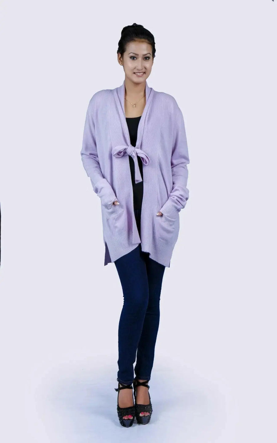 Woman wearing luxurious purple shawl collar pocket cardigan in jeans