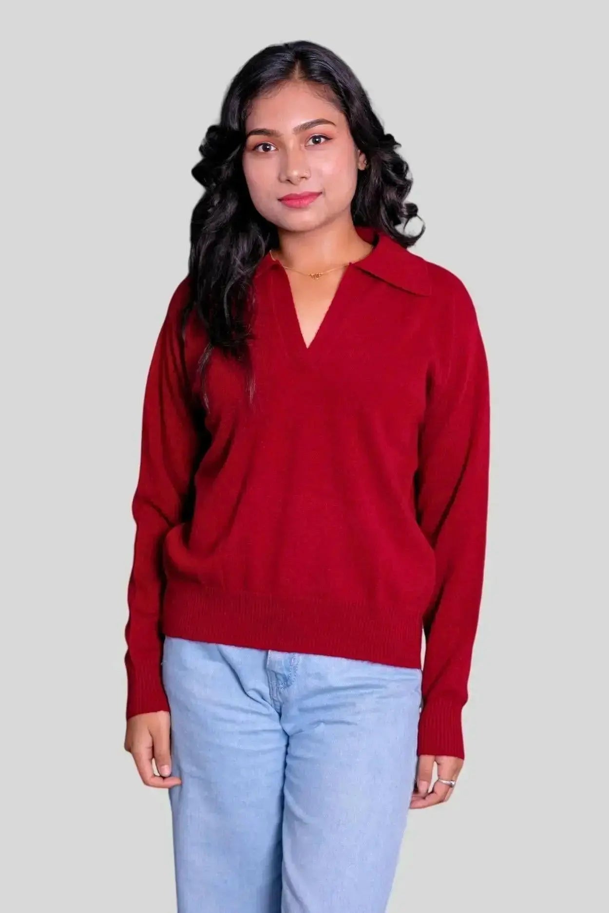 Stylish woman in red sweater and jeans, showcasing Luxurious Women’s Cashmere Polo