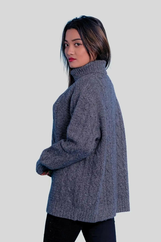 Luxuriously soft cashmere turtle neck sweater on woman in grey sweater and black pants