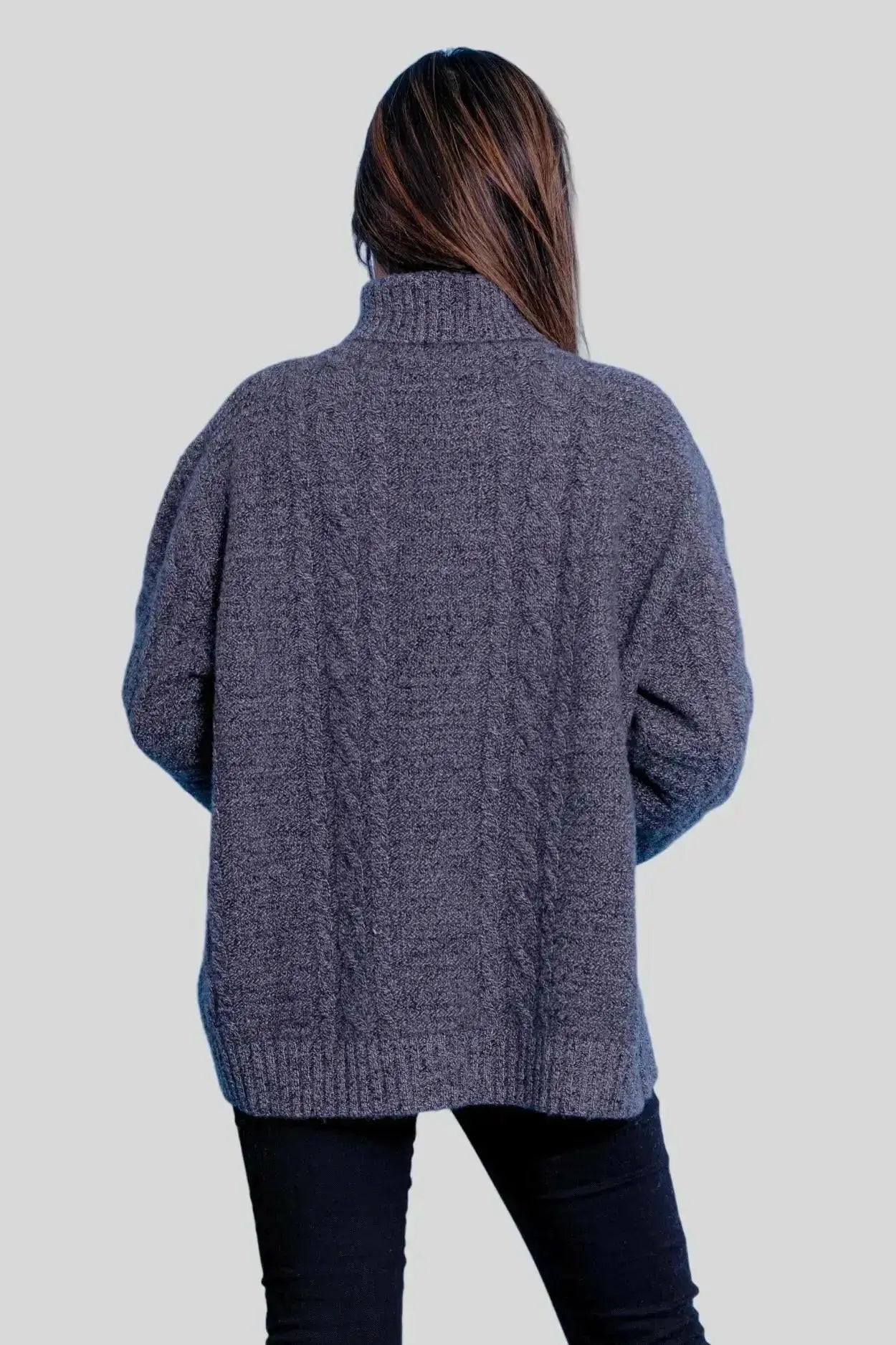 Luxuriously Soft Cashmere Turtle Neck Sweater on woman in grey sweater and black jeans