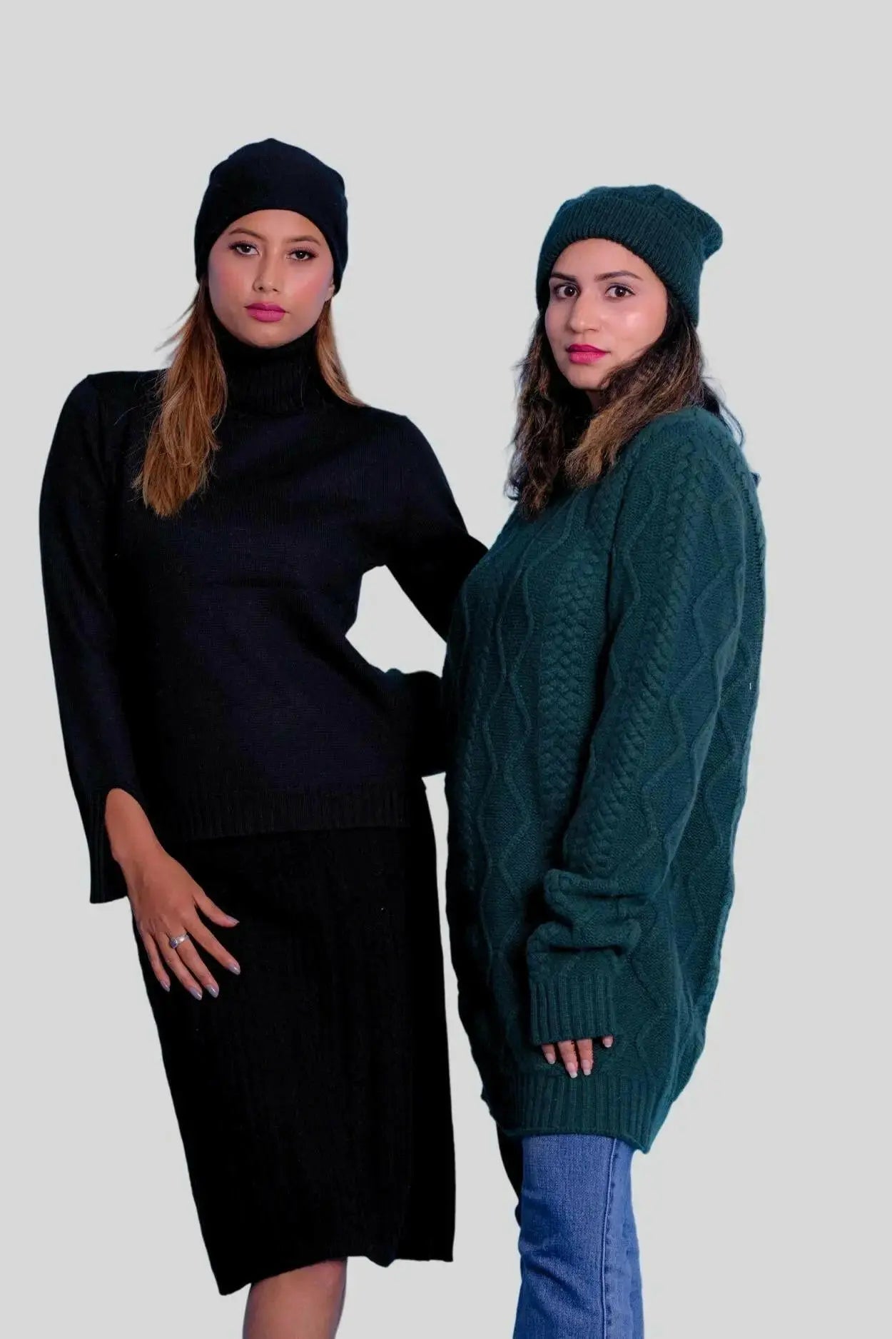 Two women in high-end cashmere dresses and hats standing together