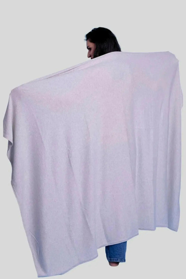 Luxury Italian Cashmere Throw: Woman wrapped in white blanket