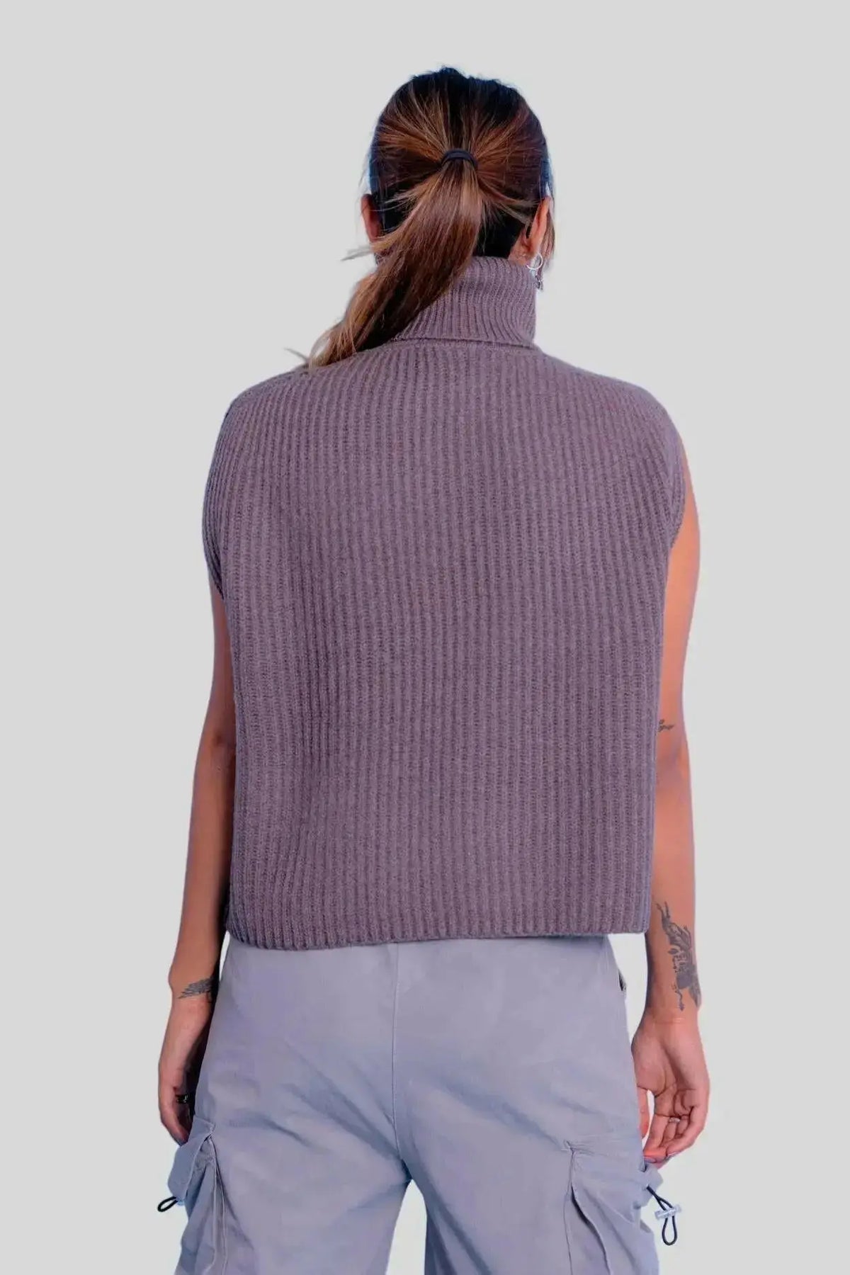 Woman wearing a purple turtle neck ribbed sweater vest from Luxury Italian Cashmere