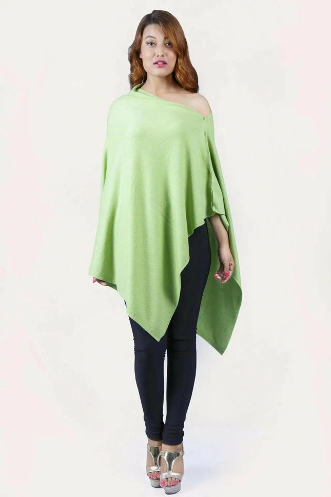 Woman wearing a green cashmere poncho from KCI 246 collection