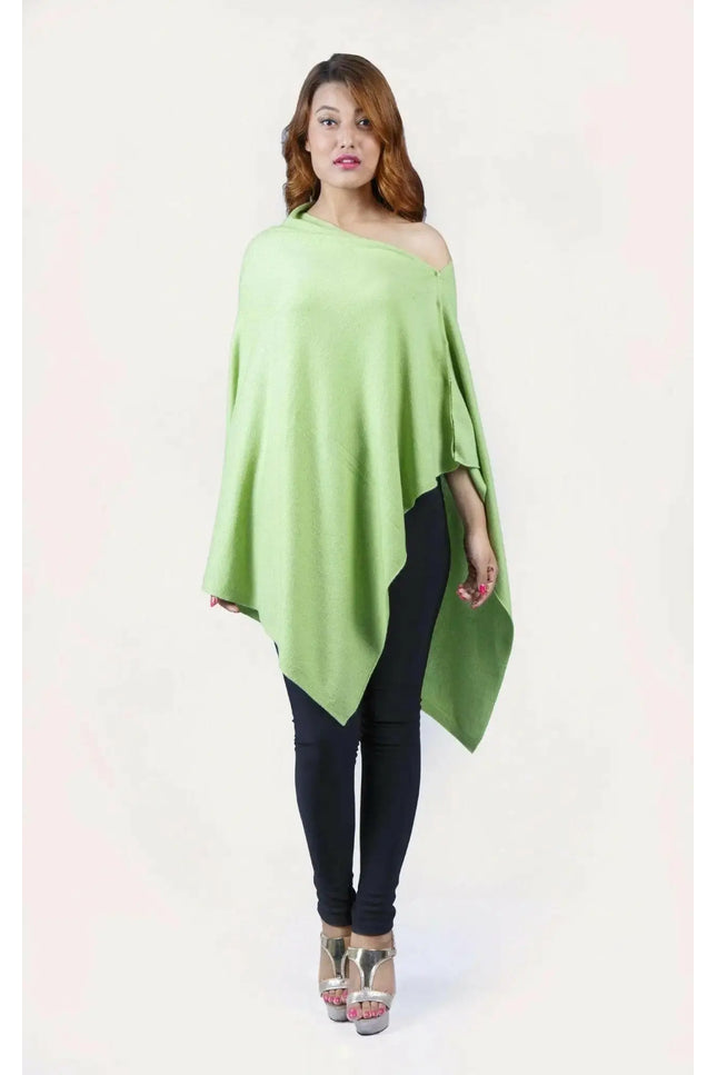 Woman wearing a green cashmere poncho from KCI 246 collection